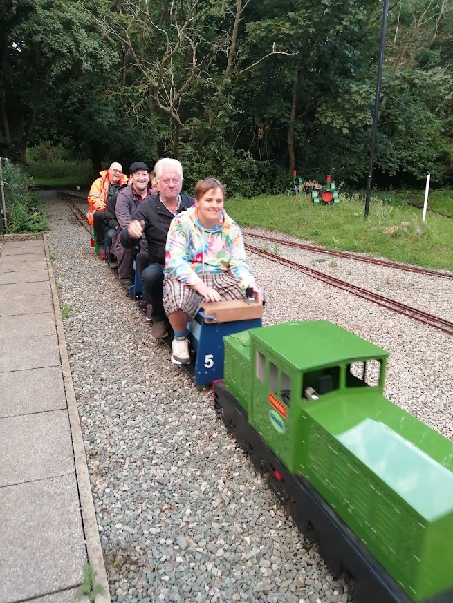 Co-workers riding the miniature railway